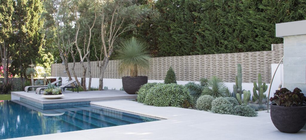 Cream fence woven on site on a low wall