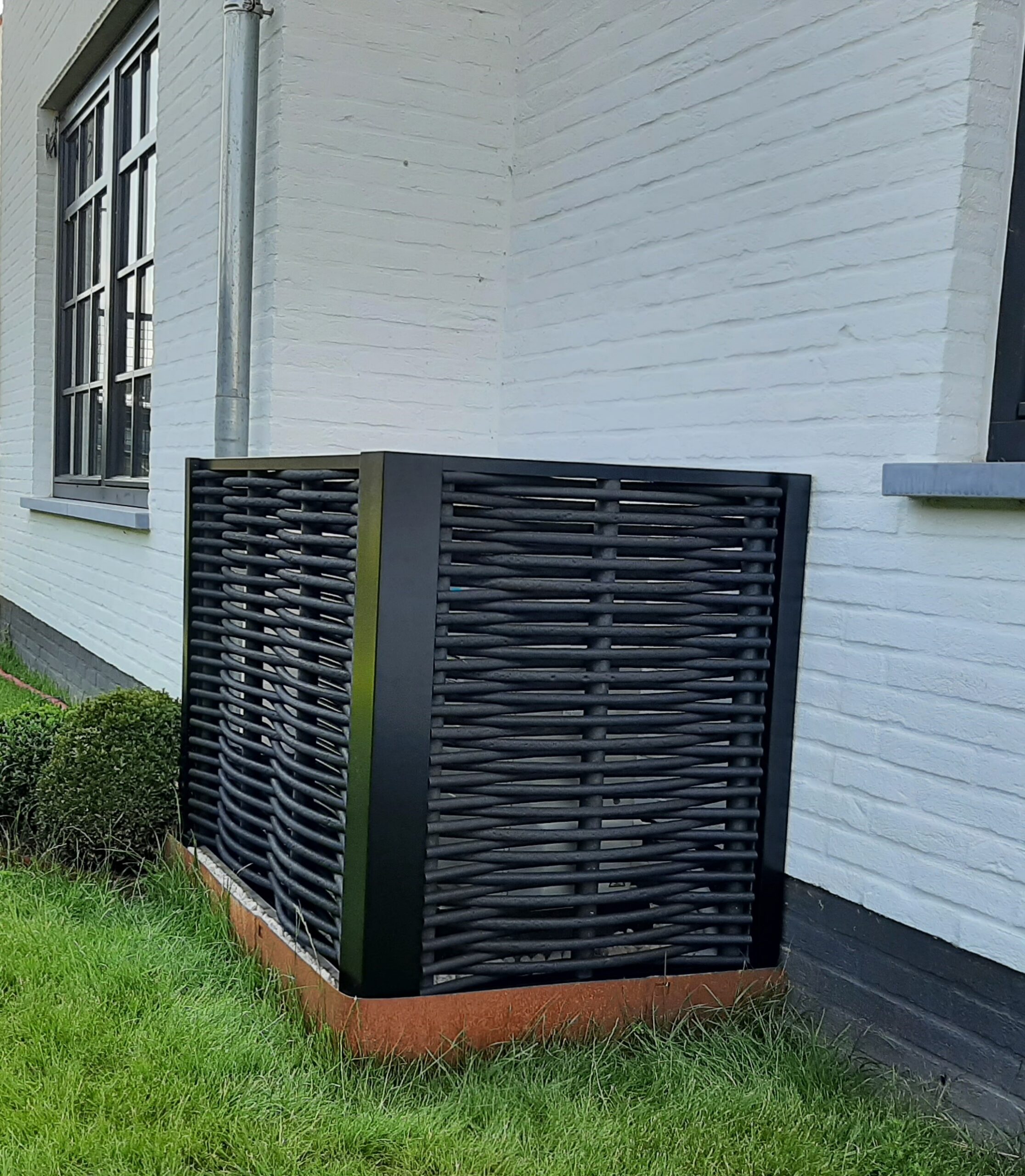 Ecowood heat pump cover with black synthetic weaving